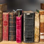 歴史を感じさせる古い本が並ぶ書棚。生活保護制度の歴史と変遷を象徴。